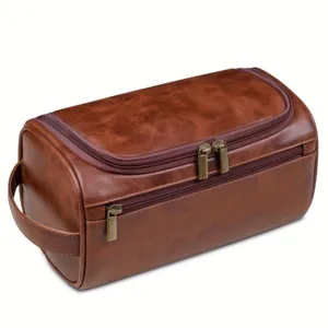 Detailed view of a brown vintage PU leather men's toiletry bag with multiple zippers