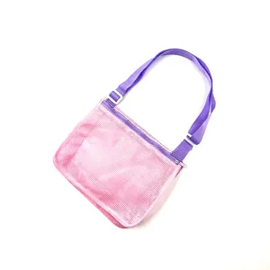 Detailed view of the pink mesh beach bag featuring a purple adjustable strap and secure zipper.