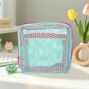 Light blue mesh cosmetic bag detail, breathable zipper pouch for travel and daily storage.