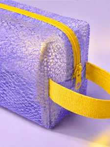 Purple mesh cosmetic bag detail view, hollow see-through travel makeup storage pouch.
