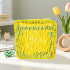 Yellow mesh cosmetic bag portable zipper storage pouch versatile makeup organizer for travel.