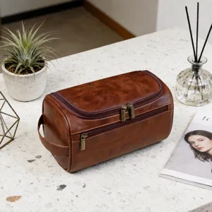 High-quality vintage brown PU leather men's toiletry wash bag on a modern marble countertop