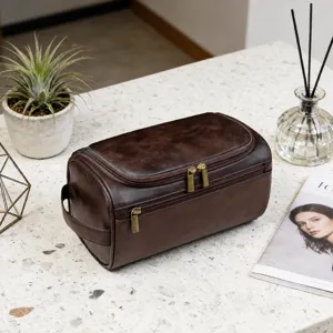 Close-up of vintage brown PU leather men's toiletry bag showing zipper details