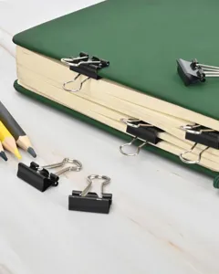 Black metal binder clips set for office documents storage and school paper organization.