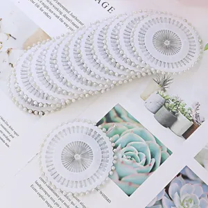 Pearl head sewing pins in white plastic wheel container, ideal for quilting, dressmaking crafts.