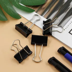 Black metal binder clips detail shot, sturdy paper clamps for office and school organization.