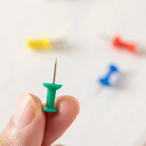 Close-up of colorful plastic push pins with stainless steel needle points for office use.