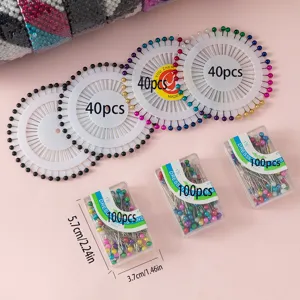Pearl head pins and straight sewing pins in wheel and box packaging for crafts and quilting.