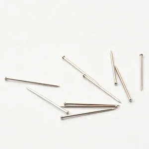 Silver straight sewing pins with round heads, ideal for fabric positioning and office use.
