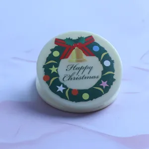 Close-up of a cute round acrylic clip featuring a festive Christmas wreath and text print.