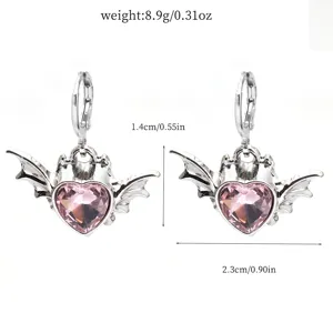 Detail view of silver devil bat wing pink heart crystal earrings with dimension specs.