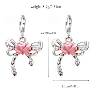 Detailed shot of cute silver bow earrings with pink rose center and dimensions shown.