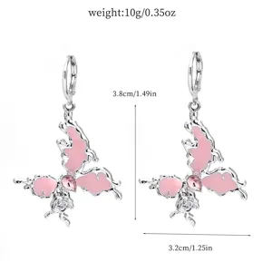 Detailed close-up of alloy crystal butterfly earrings with pink enamel and delicate rose design.