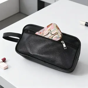 Black PU leather toiletry bag with handle and zipper for men travel organization.