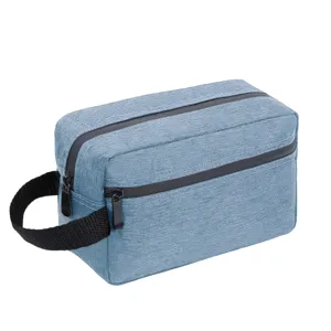Blue double layer travel toiletry bag detail, handy side strap and smooth zippers.