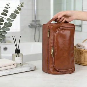 Detailed view of a premium brown PU leather toiletry bag in a modern bathroom setting