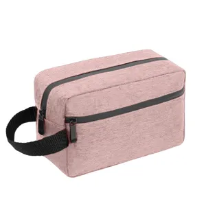 Pink oxford cloth travel toiletry bag with black handle and double zipper layers.