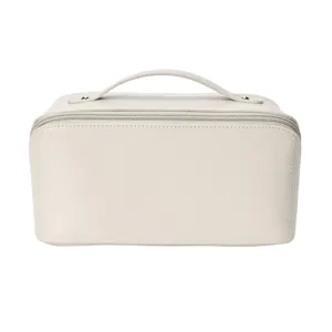 Close-up detail of the portable PU leather cosmetic bag zipper and handle for travel storage.
