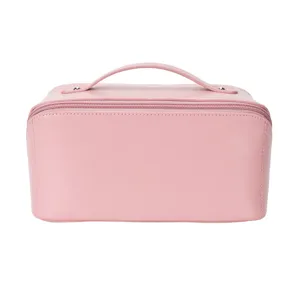 Pink PU leather cosmetic makeup bag with convenient handle and zipper detail for travel.
