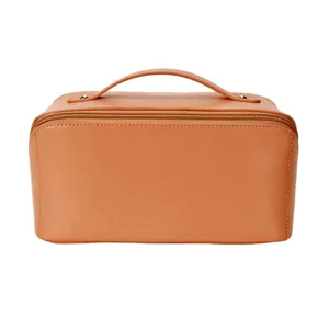 Detailed close-up of brown PU leather cosmetic bag zipper and handle design texture.