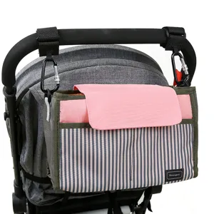 Multifunctional stroller organizer bag with pink flap and striped design for pram.