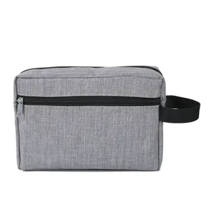 Graue Reise-Kulturtasche mit schwarzem Griff und Fronttasche für Herren und den Alltag.