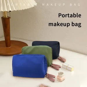 Portable mini makeup bag detail view, multi-color storage pouch with zipper and handle.