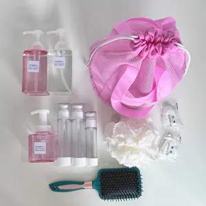Draagbare reistoilettas set met nettas, lege navulbare flessen, spons en haarkam.
