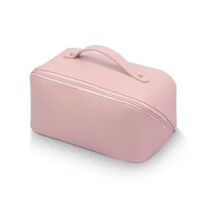 Pink PU leather cosmetic bag with handle and zipper, large capacity travel toiletry bag.