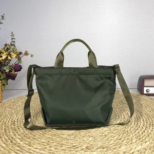 Casual green nylon tote bag, versatile handbag with shoulder strap for daily travel use.
