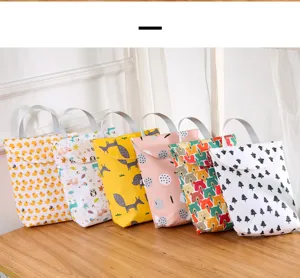 Detail shot of waterproof hanging diaper bags with cute prints and durable straps.
