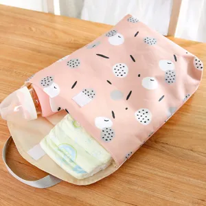 Waterproof baby diaper bag organizer with cute pattern displayed on wooden table, ideal for stroller.