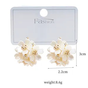 Elegant white flower cluster stud earrings with sparkling rhinestones for chic daily wear.
