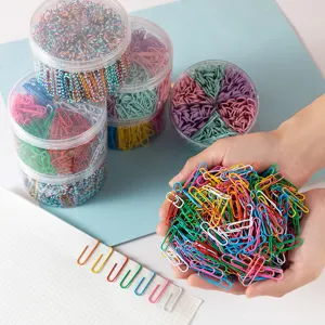 Detailed view of assorted colorful metal paper clips inside transparent storage containers.