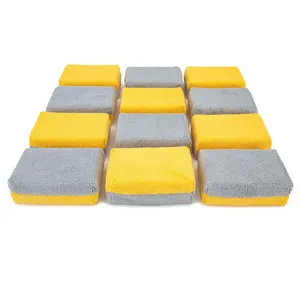 Detail view of dual-color microfiber car washing sponge blocks for waxing and cleaning.