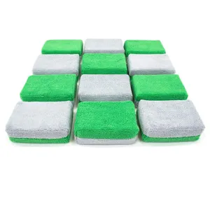 Detail shot of dual-color microfiber car waxing sponge block, soft and absorbent texture.