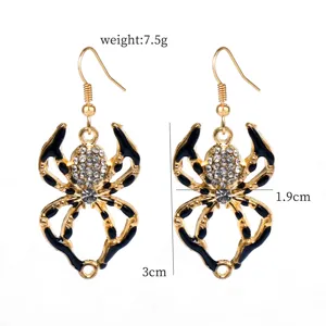 Gold spider drop earrings with sparkling rhinestones and black enamel details for Halloween.