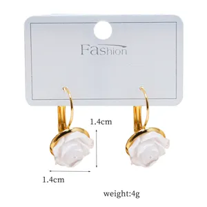 Chic gold-tone hoop earrings featuring elegant white rose flower charms, perfect for daily wear.