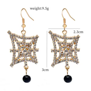 Detailed view of vintage rhinestone hollow earrings with black drop bead, size and weight.