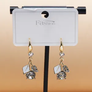 Gold-plated drop earrings featuring white enamel leaves and sparkling crystal stones.