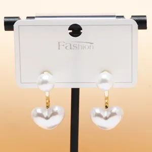 Elegant double pearl heart earrings with gold metal connector, chic daily jewelry accessory.