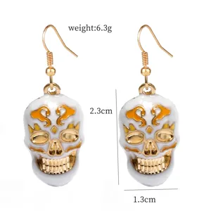 Gothic white skull drop earrings with gold tone details, elegant fashion jewelry for women.
