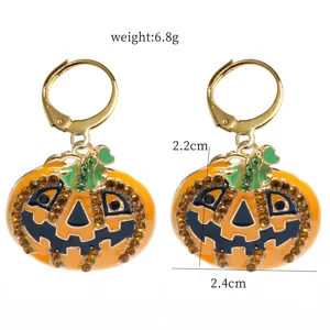 Detailed view of Halloween rhinestone pumpkin earrings with enamel details and leverback hooks.