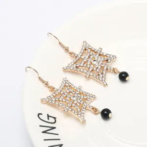 Exquisite geometric rhinestone dangle earrings featuring shiny crystals and black bead accents.