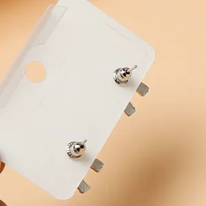 Detailed view of metal stud earrings back with card packaging, simple and classic style.