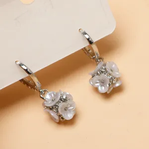 Close-up detail of silver-tone hoop earrings featuring charming crystal flower clusters.