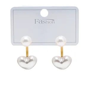 Chic double pearl heart earrings with gold connecting bar, elegant fashion jewelry for women.