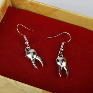 Quirky creative tooth shaped drop hook earrings for women, fun silver metal jewelry gift.