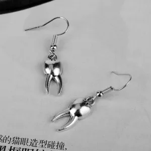 Detailed view of creative funny tooth shaped drop earrings, unique alloy silver hook jewelry.