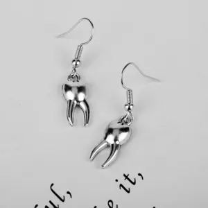 Creative funny tooth drop earrings for women, unique silver metal hook jewelry details.